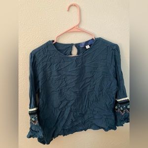 Turquoise blouse with embroidery detail on sleeves